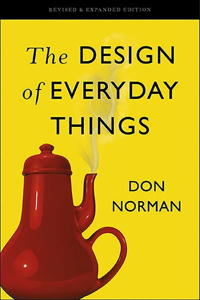 The Design of Everyday Things by Don Norman. Cover art of the book shows a red teapot with the handle and spot on the same side on a yellow background.